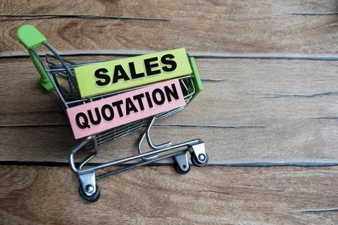 Concept of sales quotation write on sticky notes isolated on Wooden Table. Stock Photos