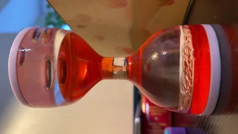 Concept of sand clock but with fluid. Vertical 4k footage. Stock Footage 283828206