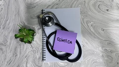 Concept of Sciatica write on sticky notes isolated on Wooden Table. Stock Photos