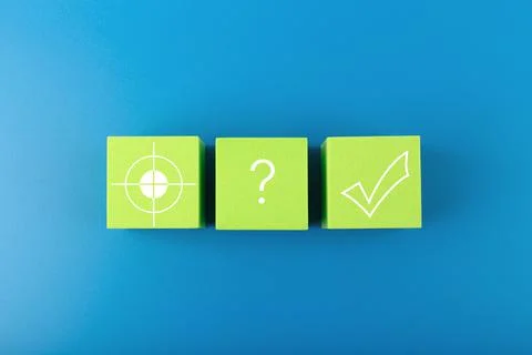Concept of scoring a goal. Target, question sign and checkmark on green toy Stock Photos