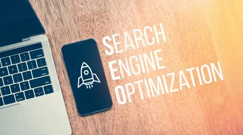 Concept Search Engine Optimization or SEO. Text with rocket icon on smartphone Stock Photos