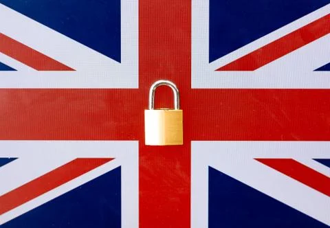Concept Of Second Lockdown in UK. Real padlock placed on top of Union Jack fl Stock Photos