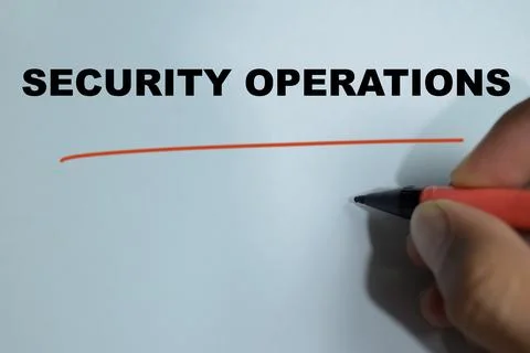 Concept of security operations write on book isolated on Wooden Table. Stock Photos
