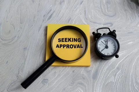 Concept of seeking approval write on sticky notes isolated on Wooden Table. Stock Photos