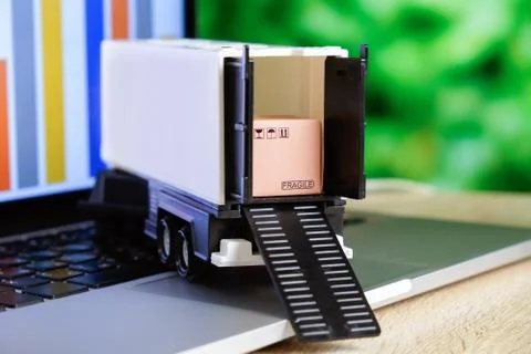 Concept of sending and tracking cargo online via transport trucks Stock Photos