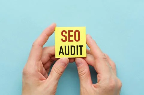 Concept of SEO Audit write on sticky notes isolated on Wooden Table. Stock Photos