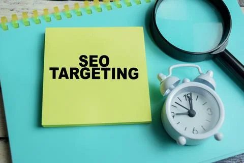 Concept of SEO targeting write on sticky notes isolated on Wooden Table. Stock Photos