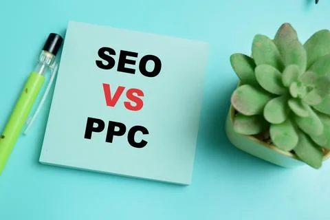 Concept of SEO vs PPC write on sticky notes isolated on table. Stock Photos