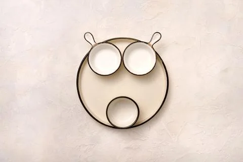 Concept set of empty light dishes in the form of animal face Stock Photos