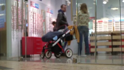 Concept shopping people at mall. Choice of glasses in the optical salon. Below Stock Footage