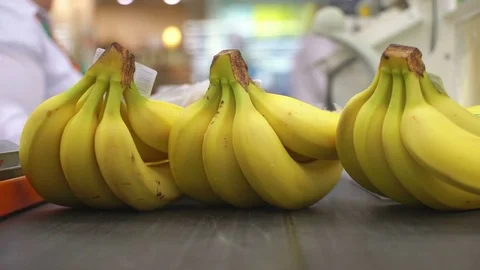 Concept shopping in supermarket. Cashier scans purchase bananas of a red laser Stock Footage