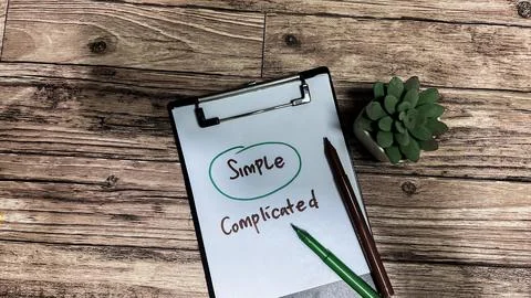 Concept of Simple or Complicated write on paperwork Stock Photos