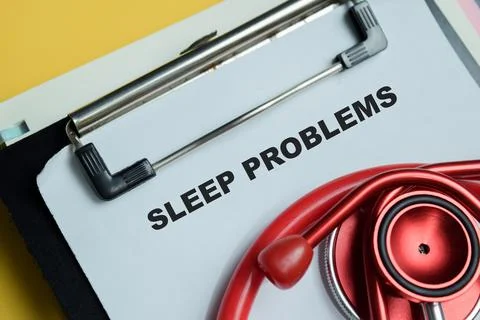 Concept of sleep problems write on clipboard isolated on Wooden Table. Photos