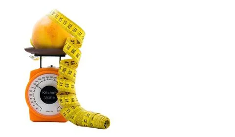 Concept of slimming regime. scale, measuring tape, peach. Stock Photos
