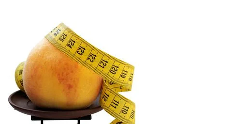 Concept of slimming regime. scale, measuring tape, peach. Stock Photos