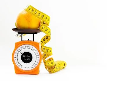 Concept of slimming regime. scale, measuring tape, peach. Stock Photos