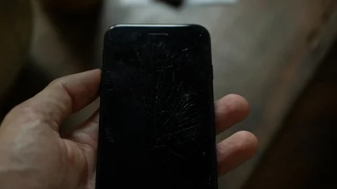 Concept of smart phone with broken screen. Top view of man hands holding a phone Video stock 117226152