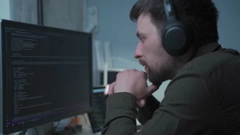 Concept of smartworking in lockdown. Man programmer in headphones sitting at at Stock Footage 153499370