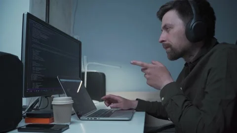 Concept of smartworking in lockdown. Man programmer in headphones sitting at at Stock Footage 153499819