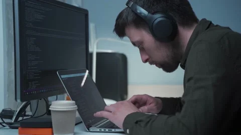 Concept of smartworking in lockdown. Man programmer in headphones sitting at at Stock Footage 153500118