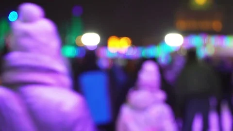 Concept Snow. Crowd at Night Skating Rink. Falling Snow. Christmas Star in Blure Stock Footage 70407651
