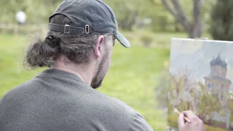 Concept Snow-white Spring. Skilled Artist Draws Paints of Blossoming Apple Tree. Video stock 70738667