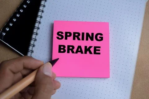 Concept of spring brake write on sticky notes isolated on Wooden Table. Stock Photos