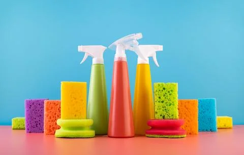 Concept of spring cleaning home. Colored supplies for cleaning on blue back.. Stock Photos