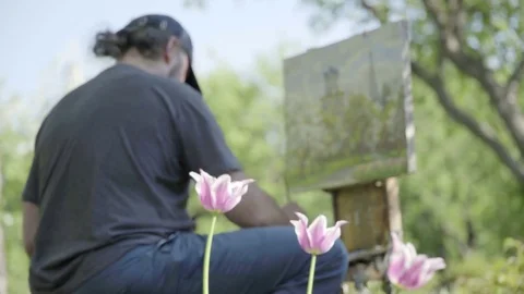 Concept Spring. Skilled Artist Draws Paints of Blossoming Tree. Follow Focus Video stock 70735698
