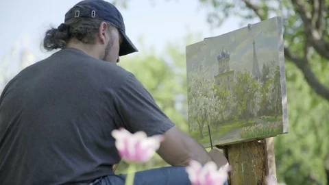 Concept Spring. Skilled Artist Draws Paints of Blossoming Tree. Follow Focus Stock Footage 85245757
