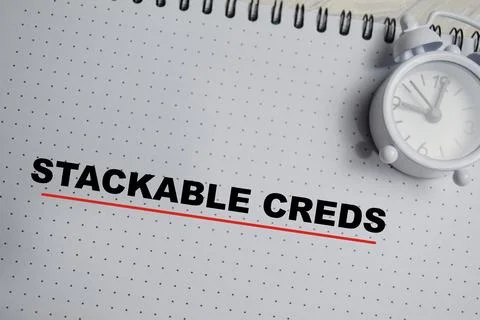 Concept of stackable creds write on book isolated on Wooden Table. Stock Photos