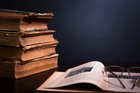 Concept still life with stack of ancient books and glasses Stock Photos