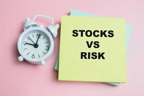 Concept of stock vs risk write on sticky notes isolated on table. Stock Photos