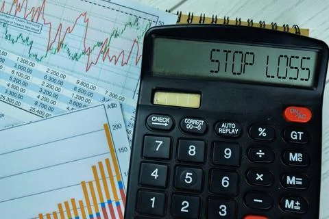 Concept of Stop Loss write on calculator isolated on Wooden Table. Foto stock