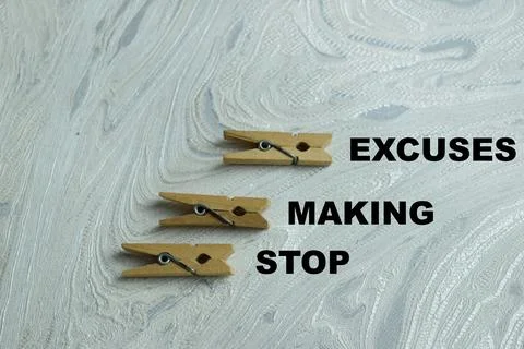 Concept of stop making excuse write on book isolated on Wooden Table. Stock Photos