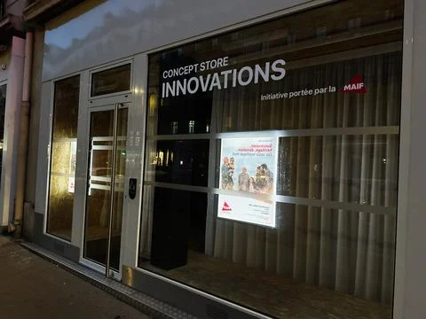 Concept store MAIF innovations storefront at night with illuminated family .. Stock Photos