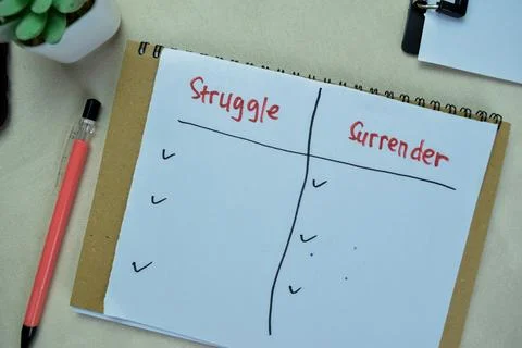 Concept of Struggle and Surrender write on paperwork isolated on Wooden Table Foto stock