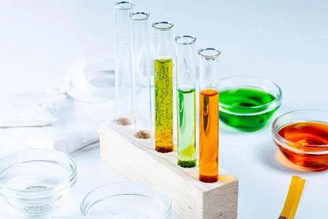 The concept of studying chemistry. Test tubes and reagents on a white backg.. Stock-Fotos