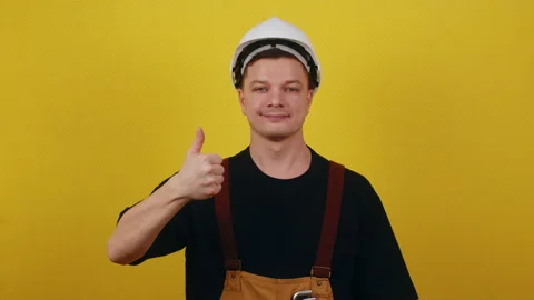 The concept of successful construction. Worker in uniform showing ok Stock Footage 172092300