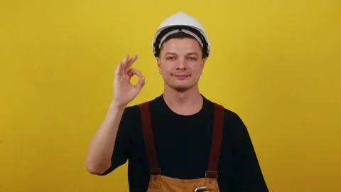The concept of successful construction. Worker in uniform showing ok Stock Footage 172092368