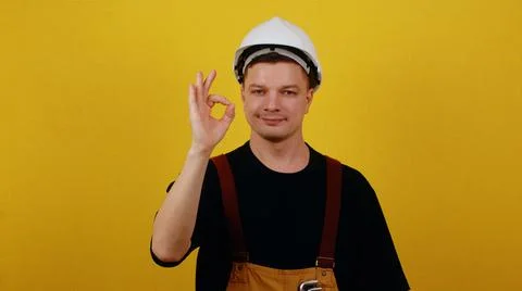 The concept of successful construction. Worker in uniform showing ok Stock Photos