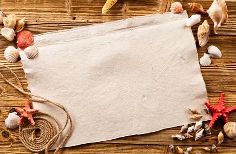 Concept of summer beach with starfish, shells and empty paper on wood Stock Photos