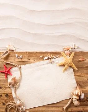 Concept of summer beach with starfish, shells and empty paper on wood Stock Photos