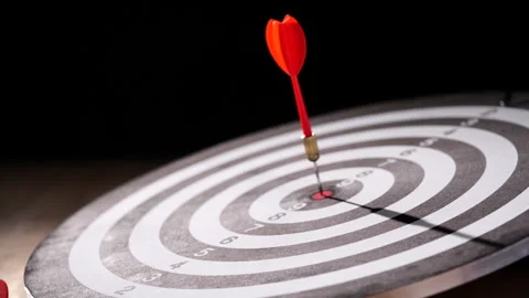 Concept target. Dolly shot red darts arrows in bullseye target or dartboard Stock Footage 293587343