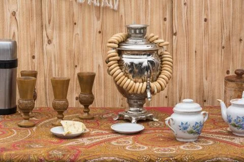 The concept of tea drinking. Samovar, bagels and tea set Stock Photos