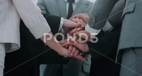 Concept of team success: business team standing with folded hand Stock Photos