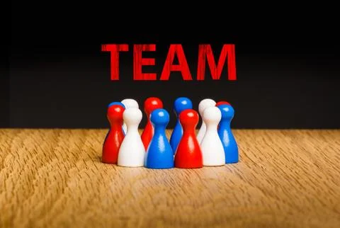 Concept for team, teamwork with red chalk text. Red white blue pawn figures a Stock Photos