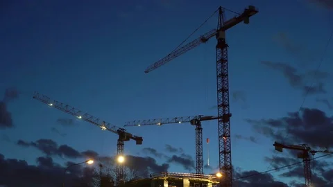 Concept teamwork, crane as symbol new life and changes in night city. Spotlight Stock Footage 73968155
