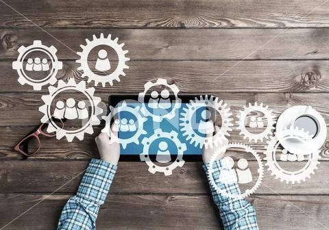 Concept of teamworking and connection with gears mechanism and tablet pc Stock Photos