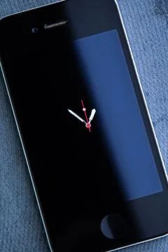 Concept of technological innovation: phone with clock hands on the screen, sh Stock Photos